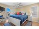 Bright main bedroom featuring a ceiling fan, balcony access, and stylish nautical decor for a relaxing getaway at 4633 Lightkeepers Way # 5H, Little River, SC 29566