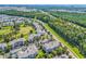 Lush aerial view of community condos next to roads and lush trees with golf course in background at 4865 Magnolia Pointe Ln. # 204, Myrtle Beach, SC 29577