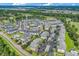 Expansive aerial view of residential community featuring condominiums, landscaping, parking and golf course at 4865 Magnolia Pointe Ln. # 204, Myrtle Beach, SC 29577