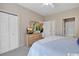 Bedroom with neutral carpet, with tv and closet visible, and doorways to the bathroom and hall at 4865 Magnolia Pointe Ln. # 204, Myrtle Beach, SC 29577