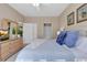 Relaxing bedroom featuring a bed with blue pillows, dresser with tv, and carpeted floors at 4865 Magnolia Pointe Ln. # 204, Myrtle Beach, SC 29577