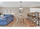 Open-concept dining and living area with hardwood floors, modern decor, and a bar counter with seating at 4865 Magnolia Pointe Ln. # 204, Myrtle Beach, SC 29577