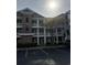 Comfortable condominium building with multiple stories, exterior balconies, and well-maintained parking at 4865 Magnolia Pointe Ln. # 204, Myrtle Beach, SC 29577