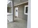 Welcoming condo entrance featuring a decorated door, neutral siding, and a pristine porch area at 4865 Magnolia Pointe Ln. # 204, Myrtle Beach, SC 29577