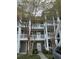 Building exterior featuring multiple balconies with white railings and well-maintained landscaping at 4865 Magnolia Pointe Ln. # 204, Myrtle Beach, SC 29577
