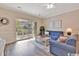 Well-lit living room with hardwood floors, sliding glass doors to a balcony, and comfortable seating at 4865 Magnolia Pointe Ln. # 204, Myrtle Beach, SC 29577