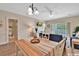 Hardwood floors in an open living space, with a view of the dining area, tv, and sliding glass door to the balcony at 4865 Magnolia Pointe Ln. # 204, Myrtle Beach, SC 29577