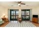 Bright living room features sliding glass doors, ceiling fan, and wood-look flooring with a patterned rug at 500 Fairway Village Dr. # 5D, Myrtle Beach, SC 29588