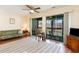 Comfortable living room with sliding glass doors to balcony, ceiling fan, and cozy seating arrangements at 500 Fairway Village Dr. # 5D, Myrtle Beach, SC 29588