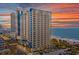 Stunning high-rise condo complex with ocean views and a colorful sunset backdrop at 504 N Ocean Blvd. # 411, Myrtle Beach, SC 29577