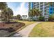 Beautifully landscaped grounds with palm trees and manicured walkways lead to the luxurious resort at 504 N Ocean Blvd. # 411, Myrtle Beach, SC 29577