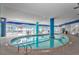 Relax in this elegant indoor pool with a bright blue column, views of the ocean and comfortable seating at 504 N Ocean Blvd. # 411, Myrtle Beach, SC 29577