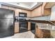 A modern kitchen with sleek black appliances and granite countertops at 504 N Ocean Blvd. # 411, Myrtle Beach, SC 29577