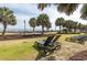 Relax on lawn chairs under shady palm trees near the beach for a serene vacation getaway at 504 N Ocean Blvd. # 411, Myrtle Beach, SC 29577