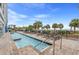 Relaxing poolside with lounge chairs, lush palms, and ocean views create a vacation paradise at 504 N Ocean Blvd. # 411, Myrtle Beach, SC 29577