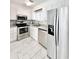 Modern kitchen with stainless steel appliances, granite countertops, and marble floors at 515 37Th Ave. N # 101, Myrtle Beach, SC 29572