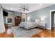 Serene bedroom with light blue walls, ceiling fan, hardwood flooring, and a large window providing natural light at 53 Hope Ln., Pawleys Island, SC 29585