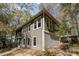 Side view of the home with a mix of siding and stone accents and lots of windows at 53 Hope Ln., Pawleys Island, SC 29585