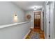 Entry hallway with hardwood floors, decorative wall accents, and a wooden front door with glass inserts at 53 Hope Ln., Pawleys Island, SC 29585