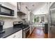 Modern kitchen with stainless steel appliances, black countertops, and a clear view into the bright dining area at 53 Hope Ln., Pawleys Island, SC 29585