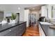 Bright kitchen features an island with seating, stainless steel appliances and beautiful hardwood flooring at 53 Hope Ln., Pawleys Island, SC 29585