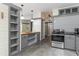 Modern kitchen with gray cabinets, stainless steel appliances, concrete flooring and updated lighting at 53 Hope Ln., Pawleys Island, SC 29585