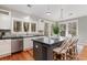 Well-lit kitchen with stainless steel appliances, a kitchen island, and a dining area with views of the backyard at 53 Hope Ln., Pawleys Island, SC 29585
