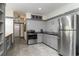Well-designed kitchen featuring stainless steel appliances, gray cabinetry, and plenty of counter space at 53 Hope Ln., Pawleys Island, SC 29585