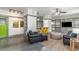 Open-concept living area with polished concrete floors, comfortable seating, and a convenient wet bar with modern yellow stools at 53 Hope Ln., Pawleys Island, SC 29585