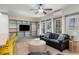 Inviting living room featuring sleek built-in shelving, a comfortable sofa, and large windows for plenty of natural light at 53 Hope Ln., Pawleys Island, SC 29585