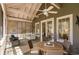 Relaxing screened porch with comfortable seating, a dining area, and a ceiling fan for those warm days at 53 Hope Ln., Pawleys Island, SC 29585