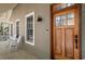 Inviting front porch featuring rocking chairs and a stylish wood door with glass panels at 53 Hope Ln., Pawleys Island, SC 29585