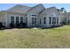 Backyard with patio, chairs, and well-manicured lawn at 59 Willowbend Dr., Murrells Inlet, SC 29576