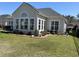 Backyard with patio, chairs, manicured lawn, and garden at 59 Willowbend Dr., Murrells Inlet, SC 29576