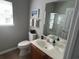 Bathroom with wood vanity, framed mirror, and walk-in shower at 59 Willowbend Dr., Murrells Inlet, SC 29576
