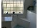 Bathroom features decorative tilework and glass block window for natural light at 59 Willowbend Dr., Murrells Inlet, SC 29576