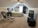 Bedroom with sloped ceilings, ceiling fan, large bed, and sitting area at 59 Willowbend Dr., Murrells Inlet, SC 29576