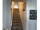 Carpeted stairway with handrail and Gathering photos on the wall at 59 Willowbend Dr., Murrells Inlet, SC 29576