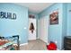 A cozy bedroom with light blue walls, a twin bed, and a decorative 'Cars' theme at 6253 Catalina Dr. # 214, North Myrtle Beach, SC 29582