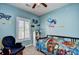 bedroom with blue walls, ceiling fan, and decorative wall decals at 6253 Catalina Dr. # 214, North Myrtle Beach, SC 29582