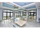Bright common area with tables, chairs, and ocean views from multiple windows at 6253 Catalina Dr. # 214, North Myrtle Beach, SC 29582