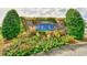 A well maintained community sign surrounded by colorful flowers and lush greenery at 6253 Catalina Dr. # 214, North Myrtle Beach, SC 29582