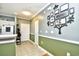 Inviting hallway featuring neutral walls with decorative trim, and a decorative Gathering tree on the wall at 6253 Catalina Dr. # 214, North Myrtle Beach, SC 29582