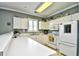A well-lit kitchen featuring white appliances and cabinets, and a tile floor at 6253 Catalina Dr. # 214, North Myrtle Beach, SC 29582