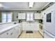 A bright kitchen featuring white cabinets, complementing countertops, and a functional layout at 6253 Catalina Dr. # 214, North Myrtle Beach, SC 29582