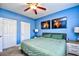 Serene main bedroom with blue walls, ceiling fan, and neutral carpet at 6253 Catalina Dr. # 214, North Myrtle Beach, SC 29582