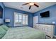 Well-lit bedroom with a ceiling fan and a mounted TV at 6253 Catalina Dr. # 214, North Myrtle Beach, SC 29582