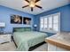 Comfortable bedroom featuring blue walls, plantation shutters, and stylish decor at 6253 Catalina Dr. # 214, North Myrtle Beach, SC 29582
