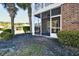 Exterior patio showcasing a brick facade, lush landscaping, and pond views at 6253 Catalina Dr. # 214, North Myrtle Beach, SC 29582
