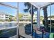 A screened patio with seating area offering scenic views of a pond and fountain at 6253 Catalina Dr. # 214, North Myrtle Beach, SC 29582